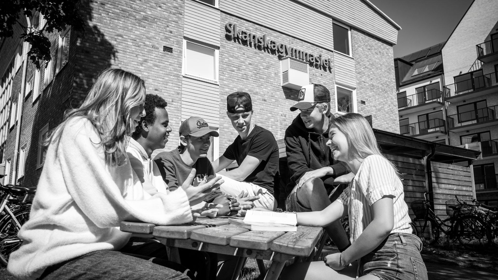 Elever vid bord utanför skolan